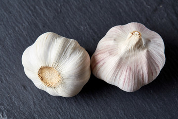 Garlic close up on wooden plate on black board,shallow depth of field, selective focus, macro