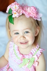 Happy cute smiling baby girl with flowers