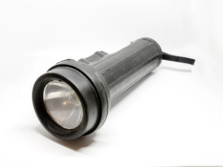 A black torch photographed against a white background.