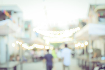 Vintage tone blurred defocused day of walking street festival in thailand bokeh background