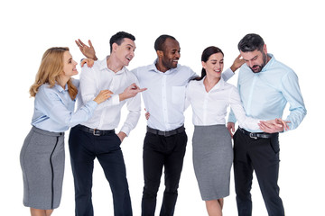 Fototapeta premium Wonderful team. Attractive content stylish young successful colleagues smiling and hugging and talking and looking at a brunette