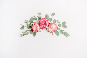 Floral composition with pink rose flower buds and eucalyptus on white background. Flat lay, top view.