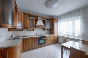 The kitchen is solid wood in a classic style in a modern house.