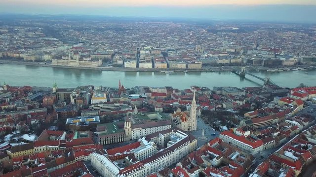 Budapest, Hungary - Aerial 4K footage about drone flying over Matthias Church with Parliament of Hungary, River Danube and Szechenyi Chain Bridge at background