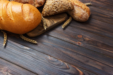 Bread and wheat on white wooden background. top view with copy space