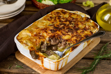 Oven dish potato gratin with minced beef and bechamel sauce
