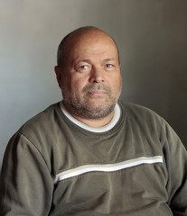 unshaven man with shaved head with critical eye