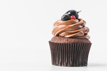 selective focus of sweet cupcakes with cream isolated on white