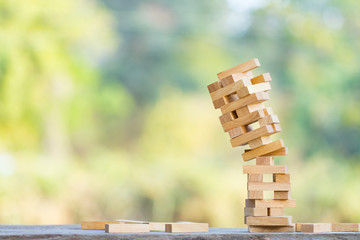 The jenga game ,tower stack from wooden blocks toy and  hand take on block