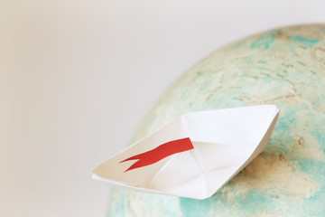Travel concept with paper boat