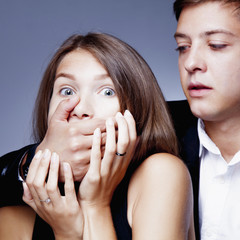  gender inequality and aggression: Man covers woman's mouth. (Fear, violence, domination concept)