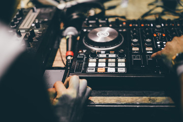 Fototapeta na wymiar Club DJ playing mixing music on vinyl turntable at party