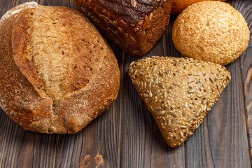 Fresh Bread assortment on wooden surface background