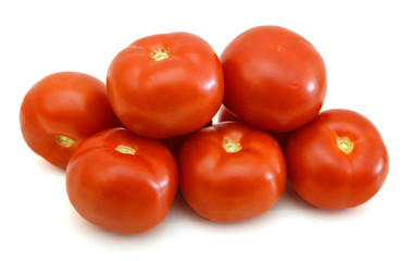 Closeup of tomatoes on the vine isolated on white