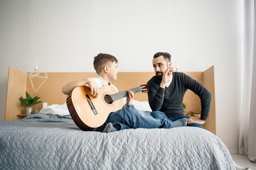 Father and son with acoustic guitar