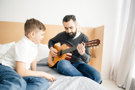 Boy and man with guitar