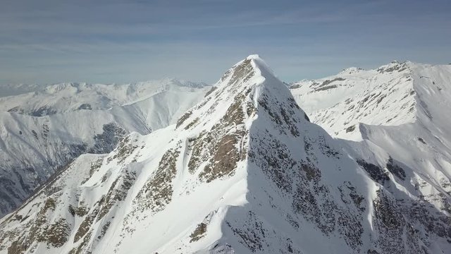 Aerial drone moving forwards in 4k - over beautiful mountains in austria cold snow winter landscape 