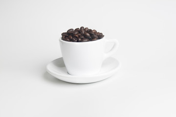 coffee beans in white cup on white background