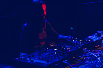 Young woman Dj playing music at Summer Party Festival . Fun, youth, entertainment and fest concept.