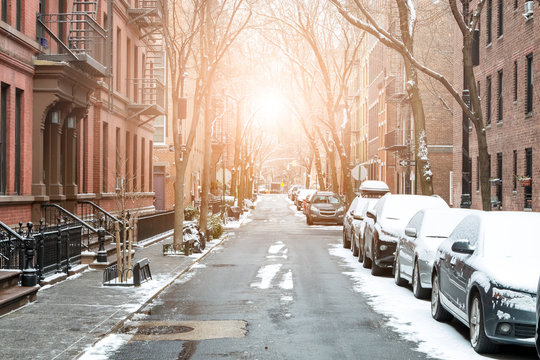 Sunlight shines on snow covered Barrow Street in Greenwich Village, Manhattan New York City