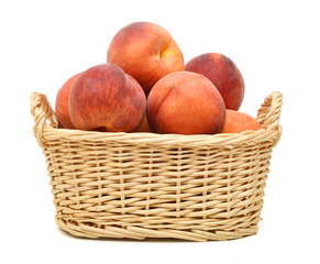 Ripe peach fruit isolated in basket on white background