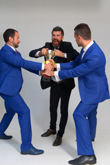 Coworkers tear winners cup as symbol of success
