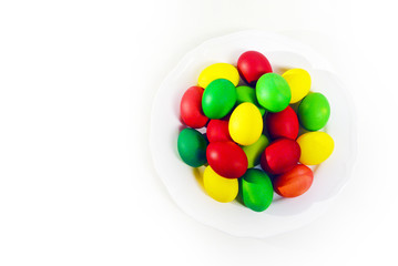 Colorful Easter eggs on white plate background. Holiday in spring season. top view composition.