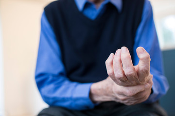 Fototapeta premium Close Up Of Senior Man At Home Suffering With Arthritis