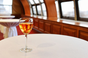One glass of wine for a banquet in an empty hall