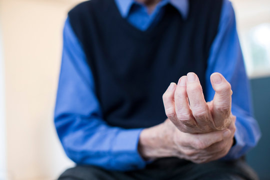 Close Up Of Senior Man At Home Suffering With Arthritis