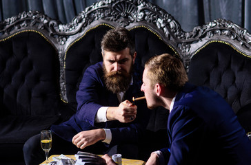 Man holding a cigar and smoking