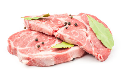 Raw pork neck meat cuts with black pepper and bay leaves isolated on white background fresh two slices without bone .