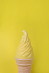 Yellow ice cream on a yellow background