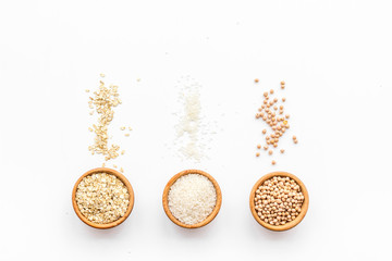 Healthy breakfast. Various cereals in bowls on white background top view copy space