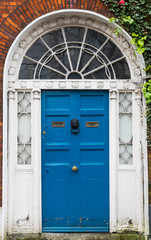 Arched blue door of Georgian styled building in Cork city, Ireland