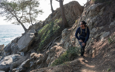 man walking among the rocks near a beach paradise