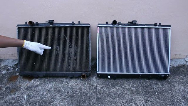 mechanic pointing radiator defective car