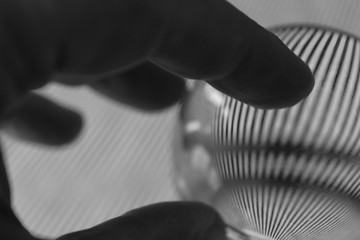 Obraz premium Hand on glass sphere with reflections