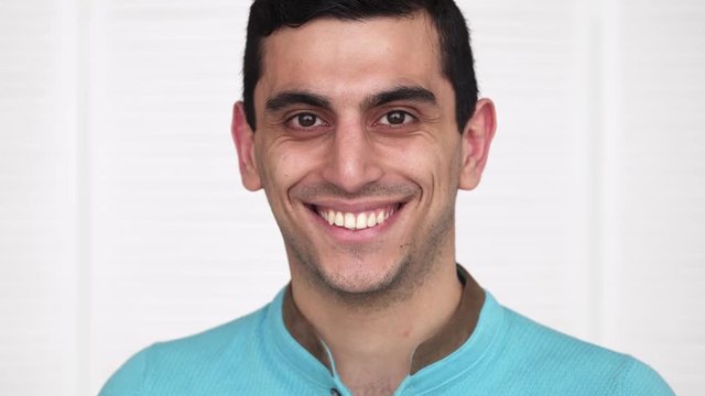 Close-up of a happy middle eastern man smiling