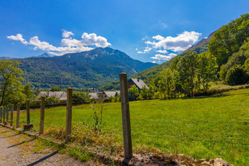Fototapeta na wymiar Small village and green meadow in the natural park of Ordesa in the Pyrenees, Huesca, Spain