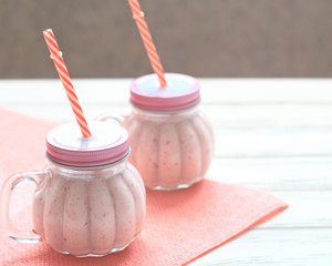 Healthy strawberry smoothie in a mason a jar mug