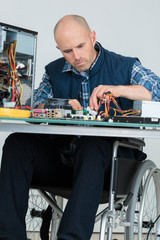 engineer in wheelchair disassembling cpu