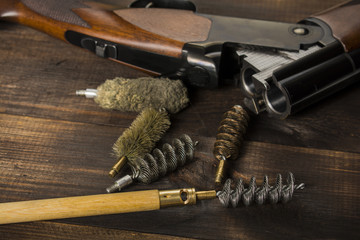 cleaning the gun on a wooden table