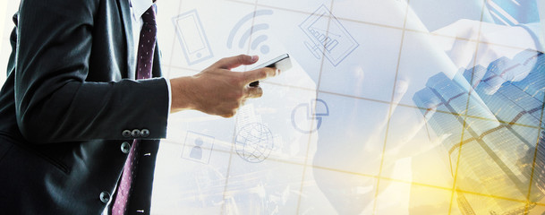 Businessman talking on the phone and using a tablet.