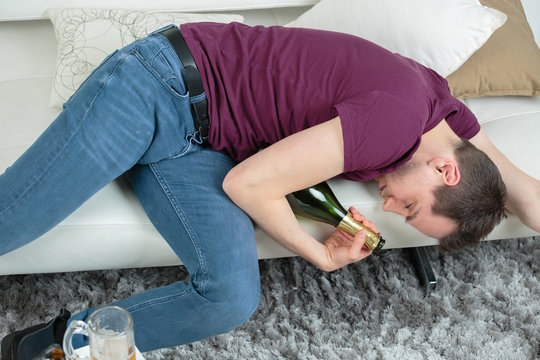 young drunk man sleeping on the sofa