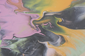 Trendy colorful artistic abstract marble background with shallow depth of field. Pink, yellow, green, black. Matte filter. Pastel colour.