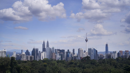 Fototapeta na wymiar Kuala Lumpur city sky line at day light with blue sky and heavy cloud.