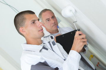 painter with apprentice and client