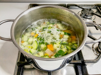 An Italian minestrone soup in a metal silver pot. Hdr effect.