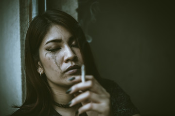 Asian woman sad from love,She smoking because stress from boyfriend,Heartbreak woman concept